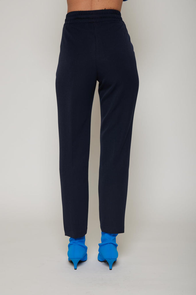 Pantalone in tessuto tecnico tasche con borchie/strass